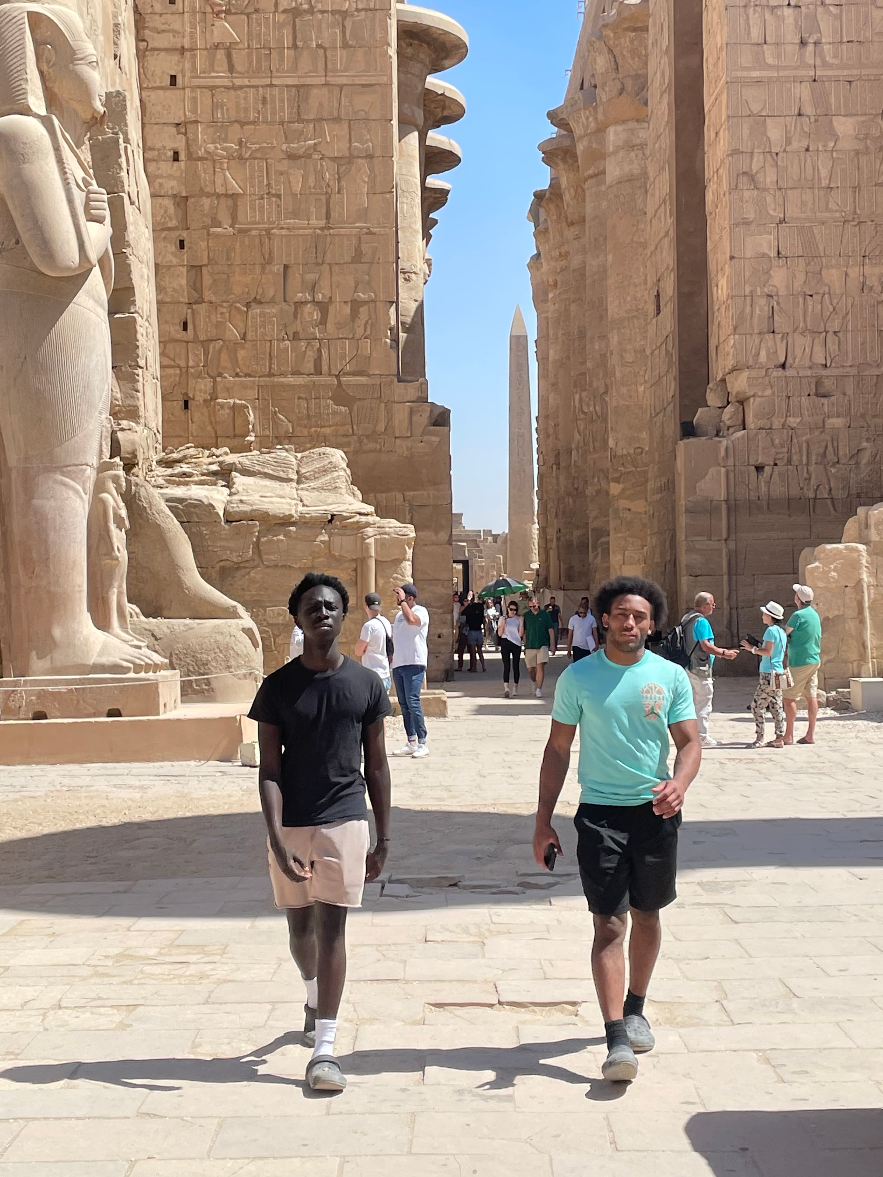 Pearson Hill and Moustapha Gueye walking through an ancient Egyptian temple courtyard — co-founders of HillWebWorks.
